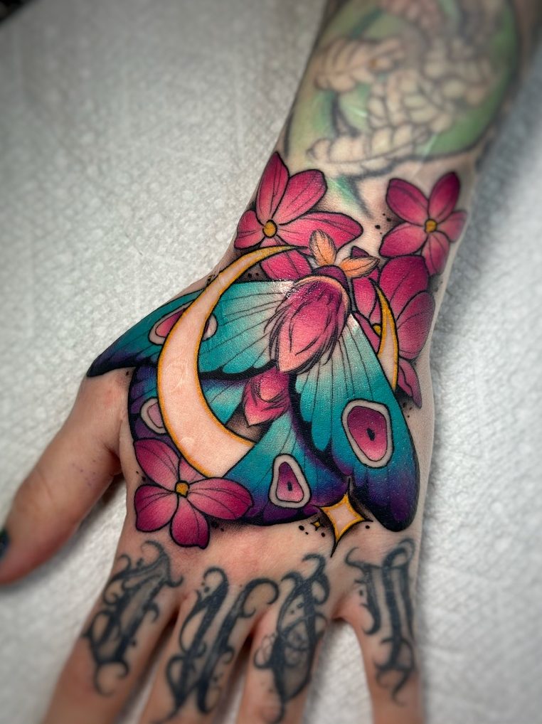 Moon moth tattoo on the hand by Tia Berry, colour tattoo artist in Vancouver