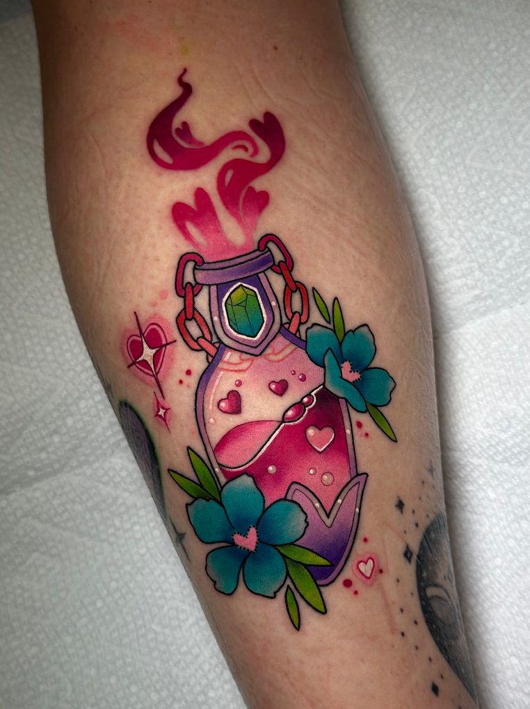 Potion bottle tattoo on the calf by Tia Berry, colour tattoo artist in Vancouver