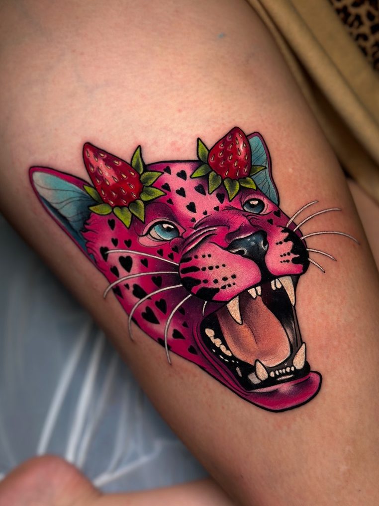 Strawberry panther tattoo on the thigh by Tia Berry, colour tattoo artist in Vancouver