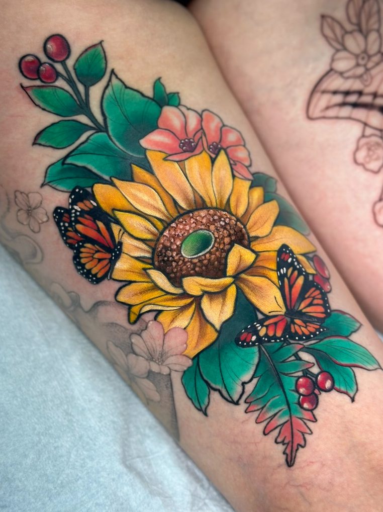 Sunflower and monarchs tattoo on the thigh by Tia Berry, colour tattoo artist in Vancouver